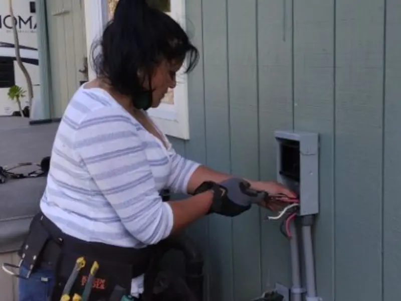 Licensed electrician wiring an exterior subpanel in Seward
